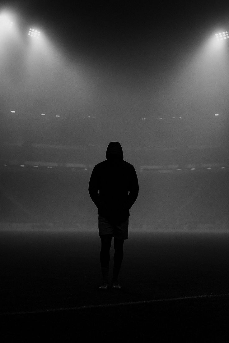 Player alone on a floodlit pitch